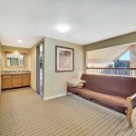 second floor loft area with futon and extra sink